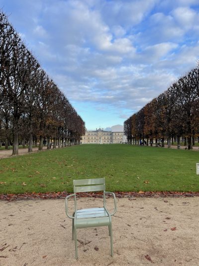 photo of a lonely chair in front of a green lawn lined with trees and a large building at the far end, illustrating that depression can negatively impact relationships and therapy can help prevent that.